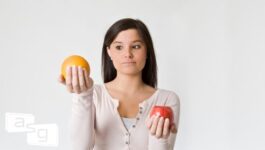 Gap Selling vs Sandler Sales Training - woman holding apple and orange, making comparison