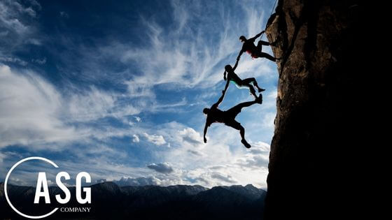 The Value of Trust in Sales Processes - climbers holding each other over a cliff