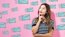 woman thinking surrounded by sales email messages