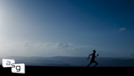 Silhouette of a runner in the early morning, symbolizing the start of a journey, set against a serene backdrop of distant hills and a clear sky. This image represents the beginning of refining one's sales process, mirroring the blog's narrative of transitioning from a casual walk to a structured sales strategy and routine.
