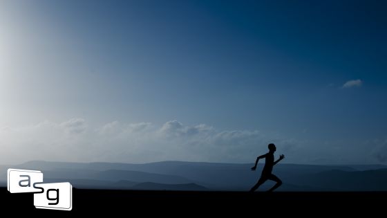 Silhouette of a runner in the early morning, symbolizing the start of a journey, set against a serene backdrop of distant hills and a clear sky. This image represents the beginning of refining one's sales process, mirroring the blog's narrative of transitioning from a casual walk to a structured sales strategy and routine.