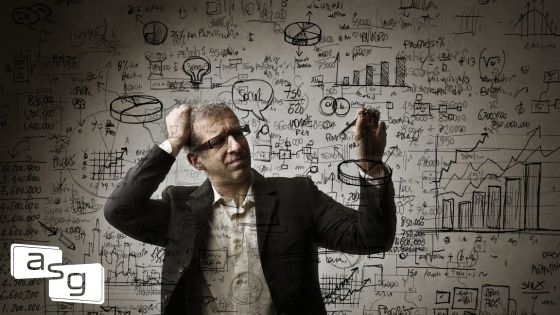 Man in business attire scratching his head, standing in front of a wall filled with complex charts, equations, and business diagrams, symbolizing the analytical challenges of aligning sales enablement strategies