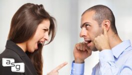 A woman angrily points her finger while a man covers his ears with his fingers, depicting a lack of coachability and the challenges in coaching uncoachable team members.