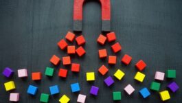 A red and black horseshoe magnet attracts red cubes while leaving other colorful cubes scattered below, visually representing the importance of attracting the right customers rather than chasing every deal. The image reflects the concept of strategic, problem-focused selling to avoid churn and build long-term retention.