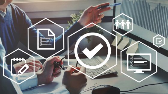 Two people reviewing sales process visuals with icons for checklists, teams, and analytics, symbolizing modern sales fundamentals